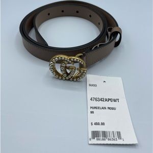Gucci womens thin rose colored belt with gold buckle and pearl accents.